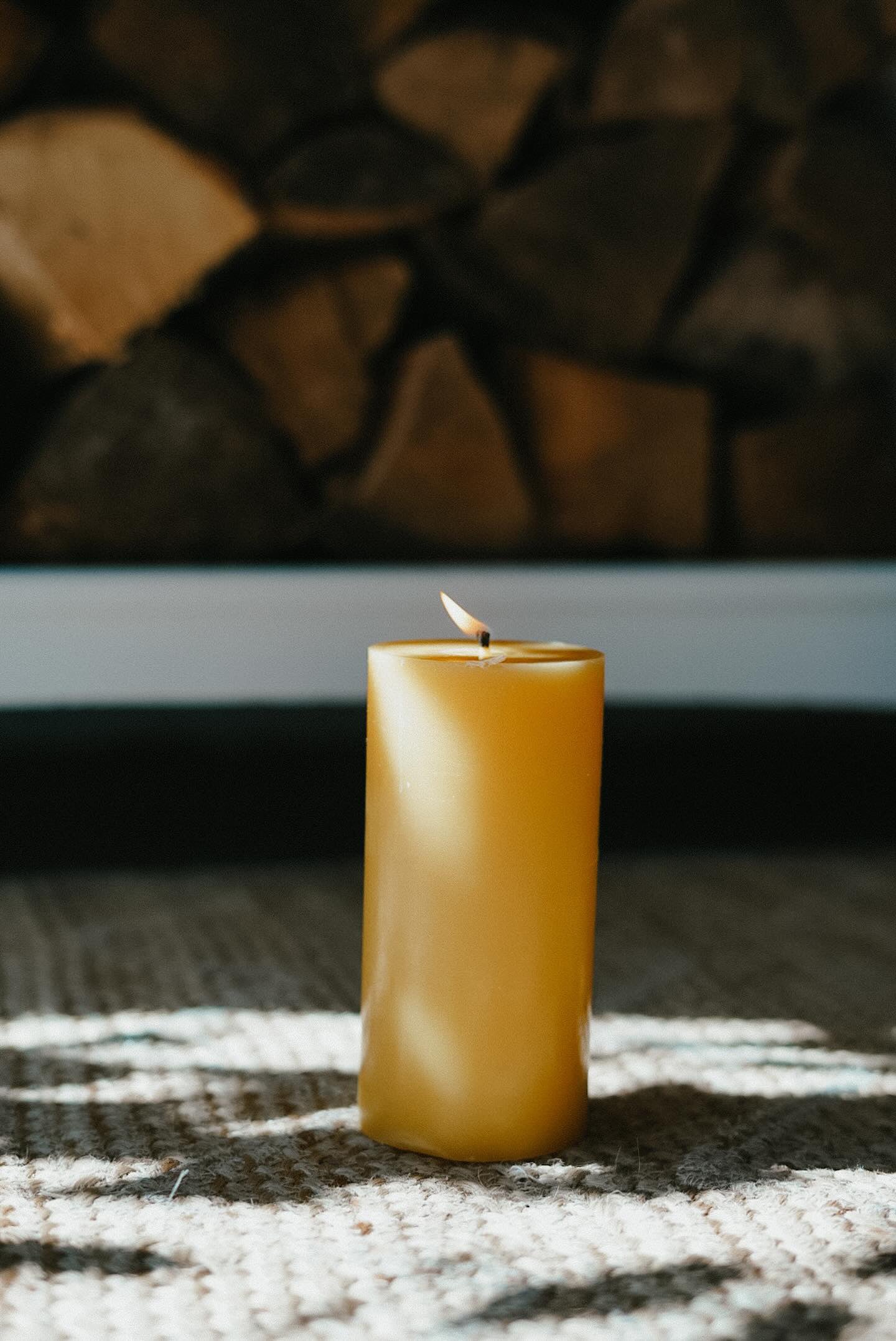 Busy Bees 3 Inch by 6 Inch pillar candle displayed outdoors beside a textured lantern in a cozy evening setting.