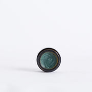 Open jar showing the teal balm texture of Code of Harmony Ceru Blue Barrier Balm