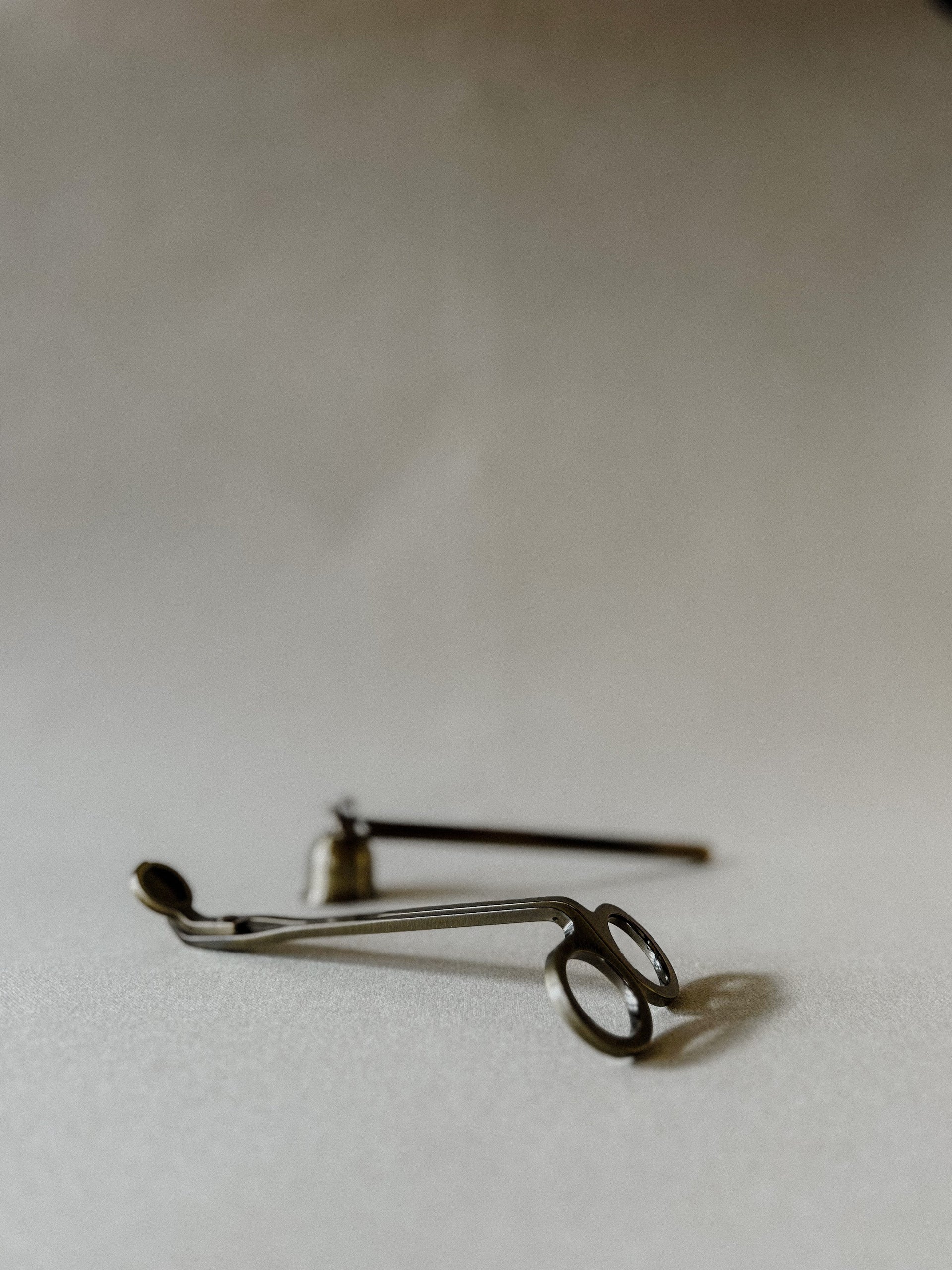 Busy Bees Candle Snuffer and Wick Trimmer set displayed on a soft neutral background with metallic candle care tools arranged side by side.