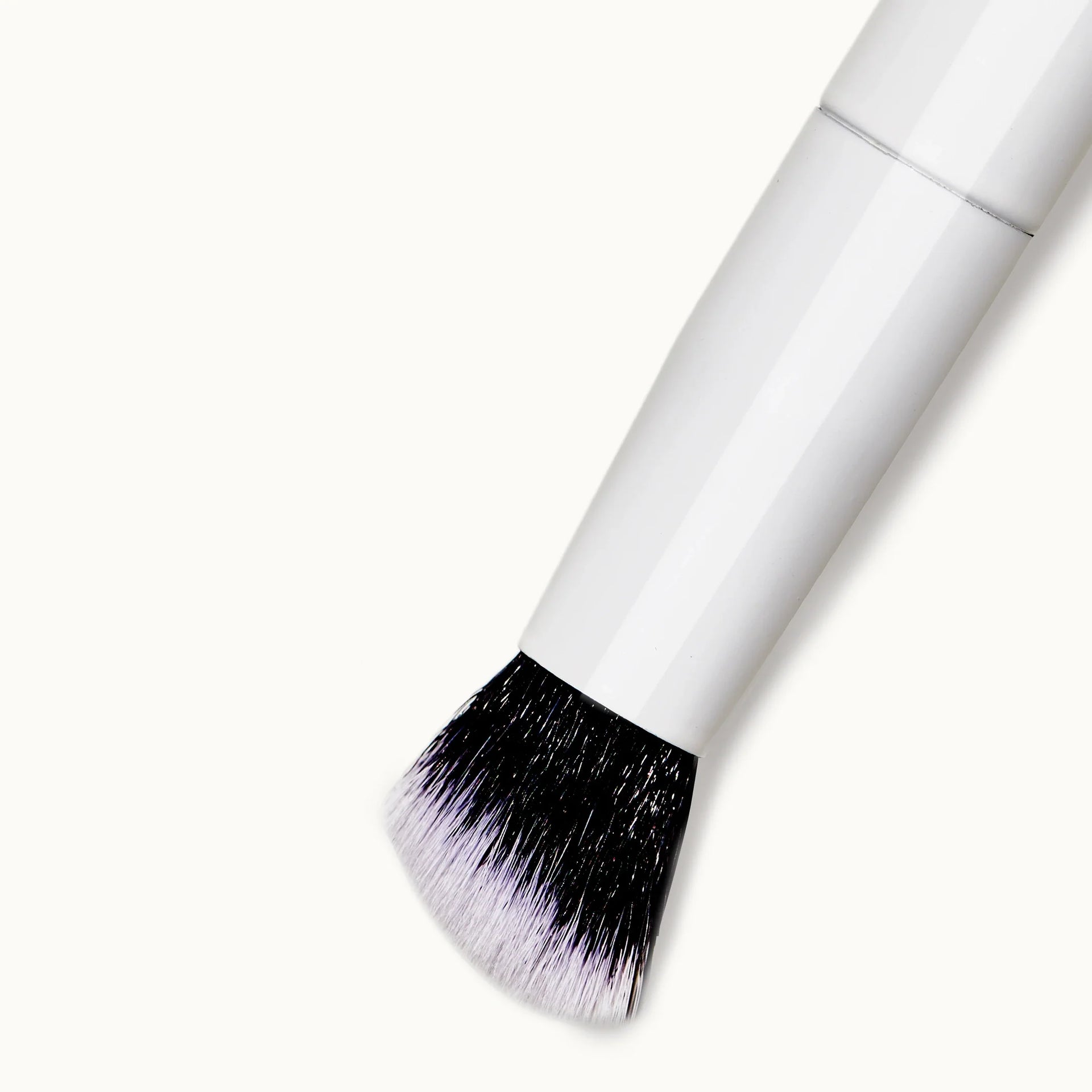 Precision tapered end of Mama Sol Buff & Blur complexion brush for targeted application