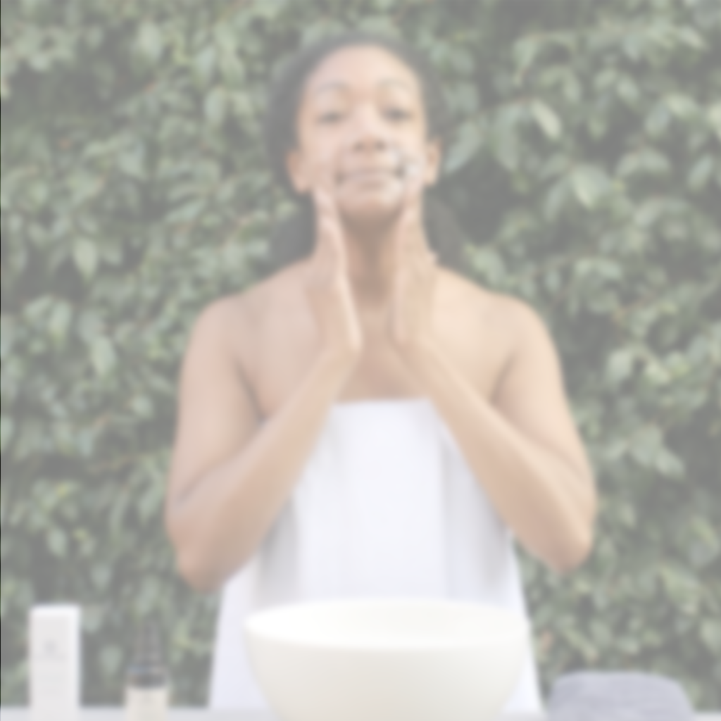 Woman using Citrus Mint Cleanser as part of a daily facial cleansing routine