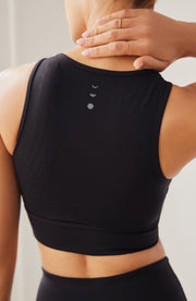 Back detail of the Elastique Athletics Le Divine Lymphatic Bra in black highlighting the racerback cut and centered logo detail.