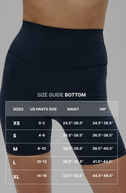 Size guide graphic for the Elastique Athletics L'Original Lymphatic Bike Short featuring measurement overlay text across navy blue bike shorts.