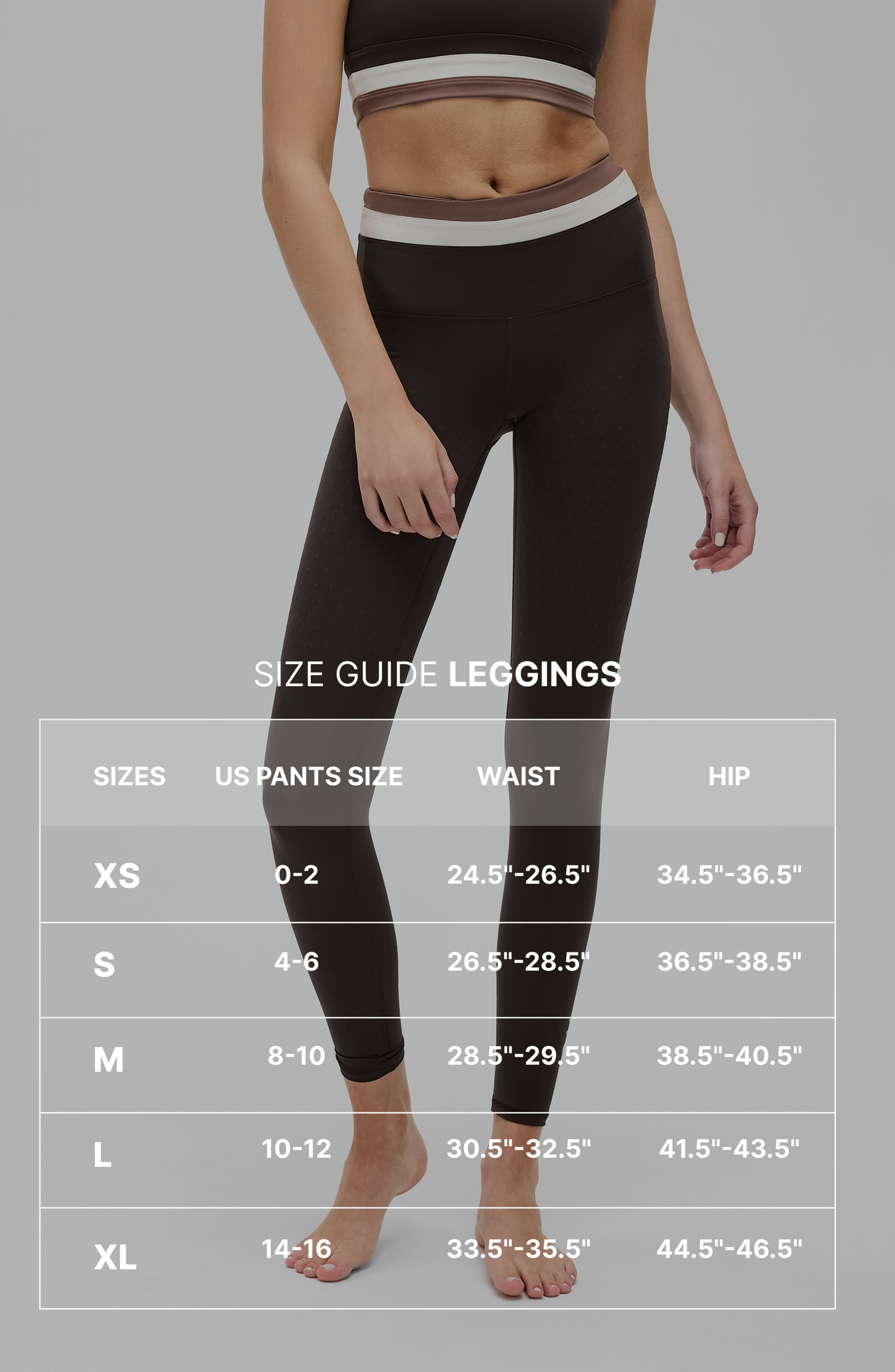 Full body portrait of a woman wearing the Elastique Athletics Le Monde black sleeveless crop top and leggings with size guide.