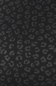 Close up fabric texture detail of the Elastique Athletics The Fierce Tank featuring a tonal black leopard print pattern.