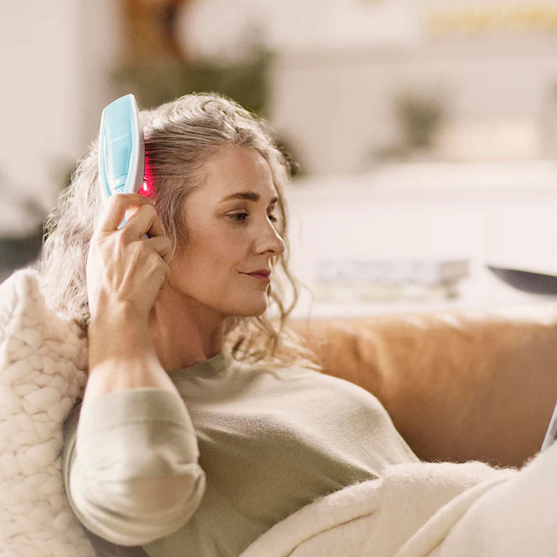 Hairmax Ultima 12 Classic LaserComb being used by a woman