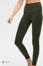 Lower body studio shot of a woman wearing the Elastique Athletics L'Original dark olive green high waisted leggings.