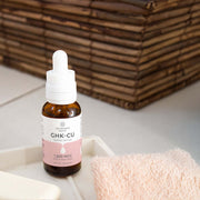 Lifestyle image of Neurogan Health GHK-Cu Neck and Face Serum on a bathroom counter.