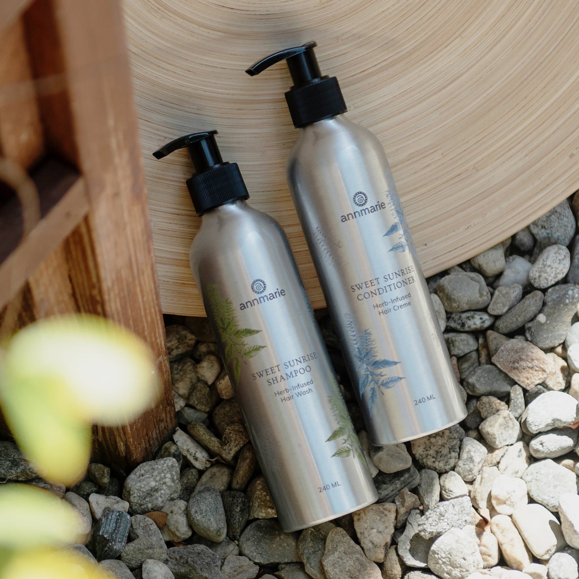Annmarie Sweet Sunrise Shampoo displayed with botanical ingredients and natural elements