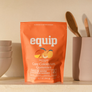 Equip Core Colostrum Gummies in Peach Mango, orange 12.7 oz pouch of grass-fed bovine colostrum gummies