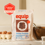 Equip Prime Protein chocolate bag on a kitchen counter with clinically proven grass-fed protein badge