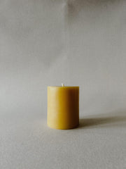 Single Busy Bees 3 Inch by 3.5 Inch pillar candle in natural yellow beeswax displayed against a soft neutral background.