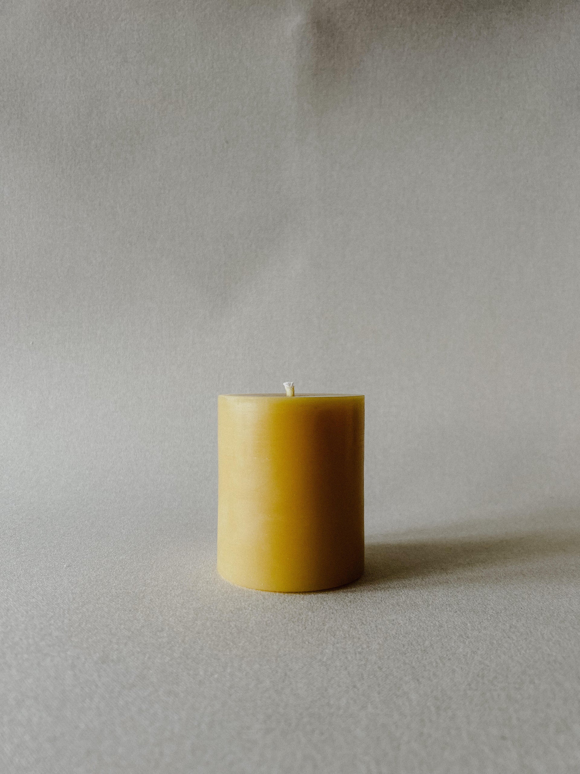 Single Busy Bees 3 Inch by 3.5 Inch pillar candle in natural yellow beeswax displayed against a soft neutral background.