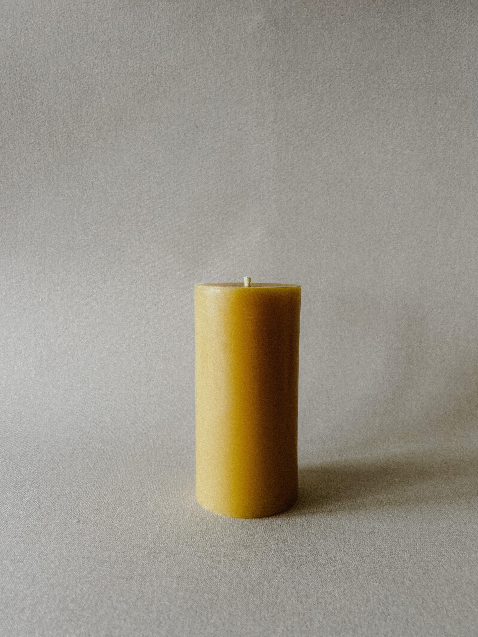 Single Busy Bees 3 Inch by 6 Inch pillar candle in natural yellow beeswax displayed against a soft neutral background.