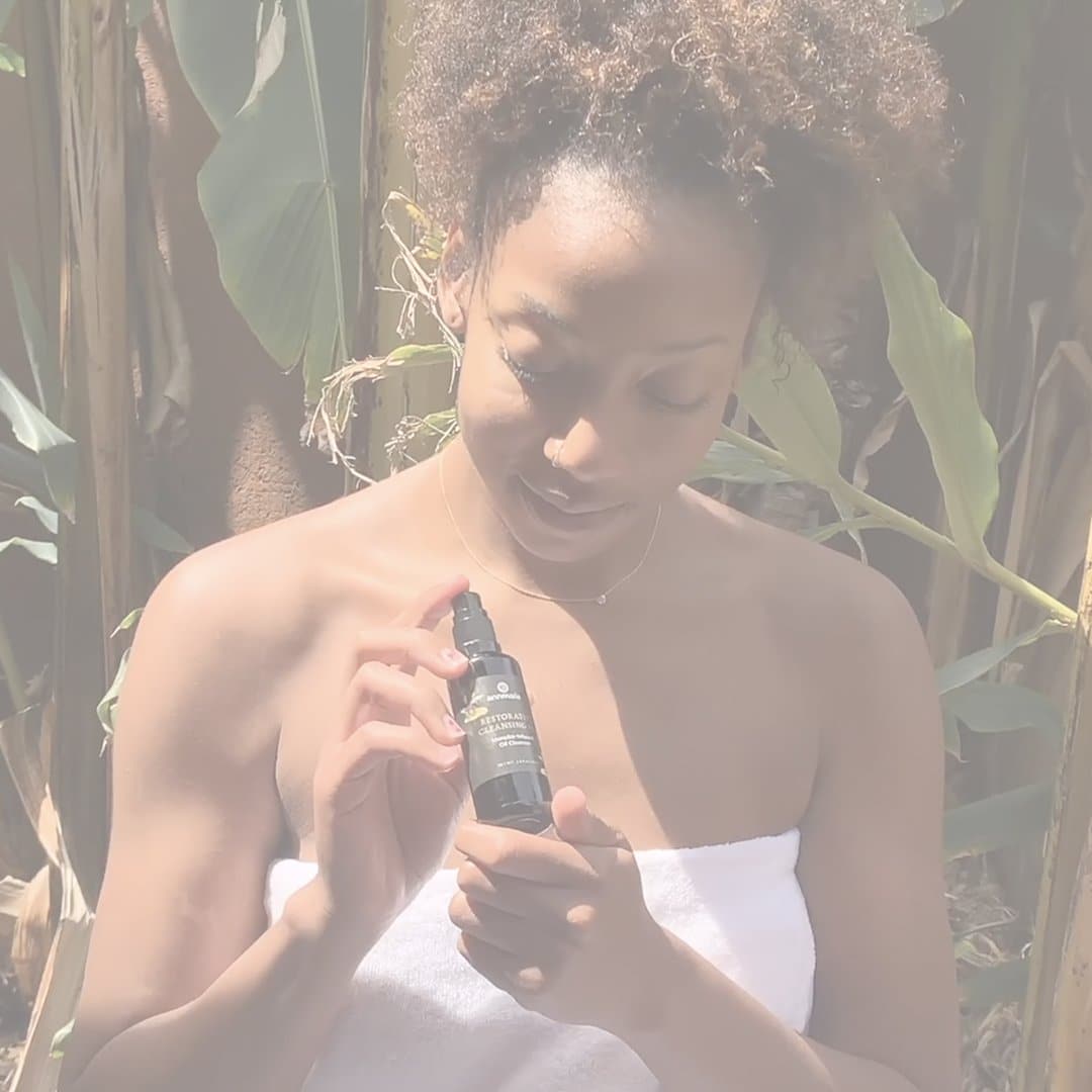 Woman using Restorative Cleansing Oil as part of a natural skincare routine