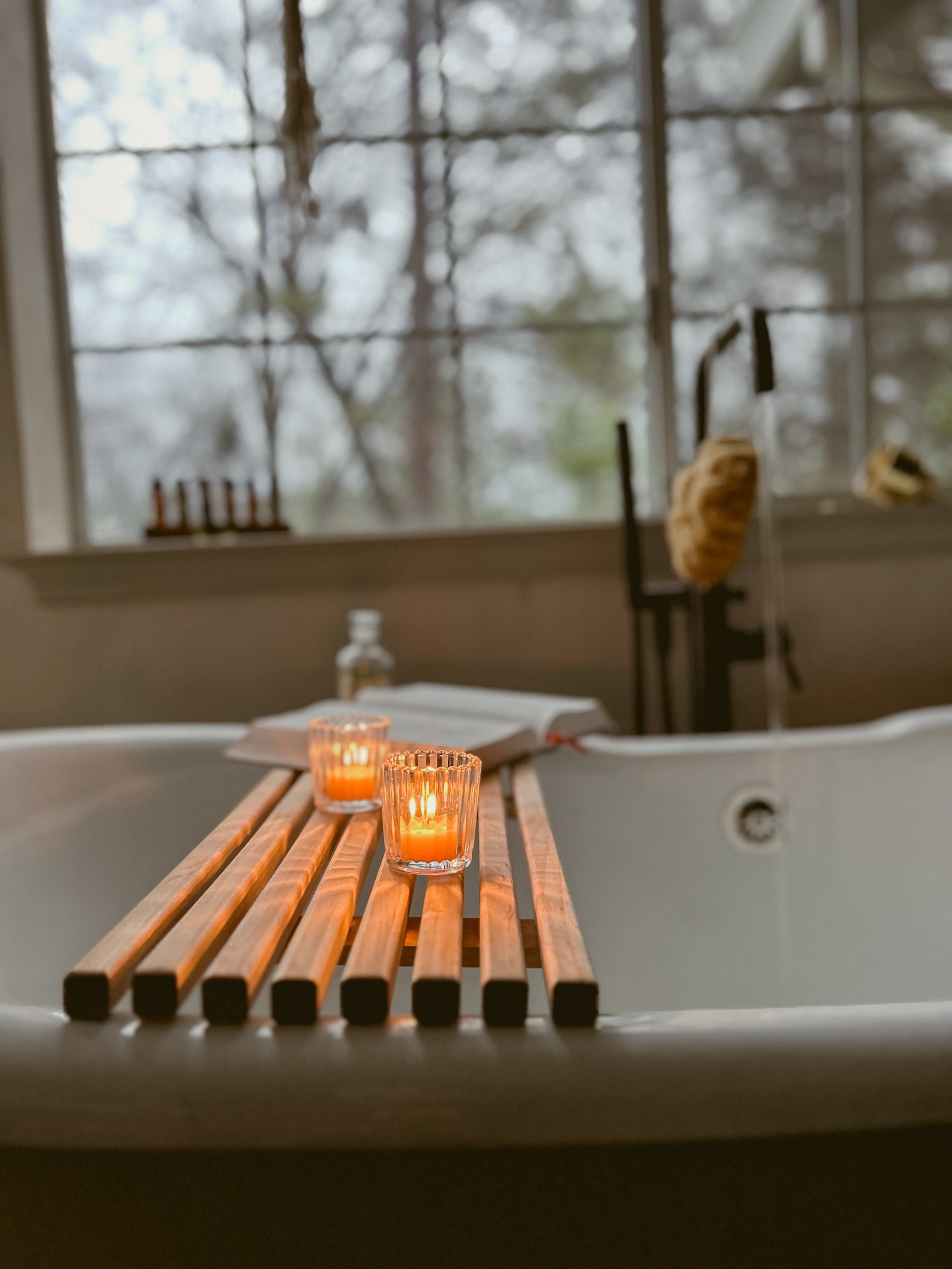 Busy Bees Ribbed Glass Tea Light Holders displayed on a windowsill beside a bottle and soft natural light.