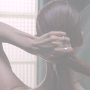 Person applying conditioner to hair during a natural hair care routine