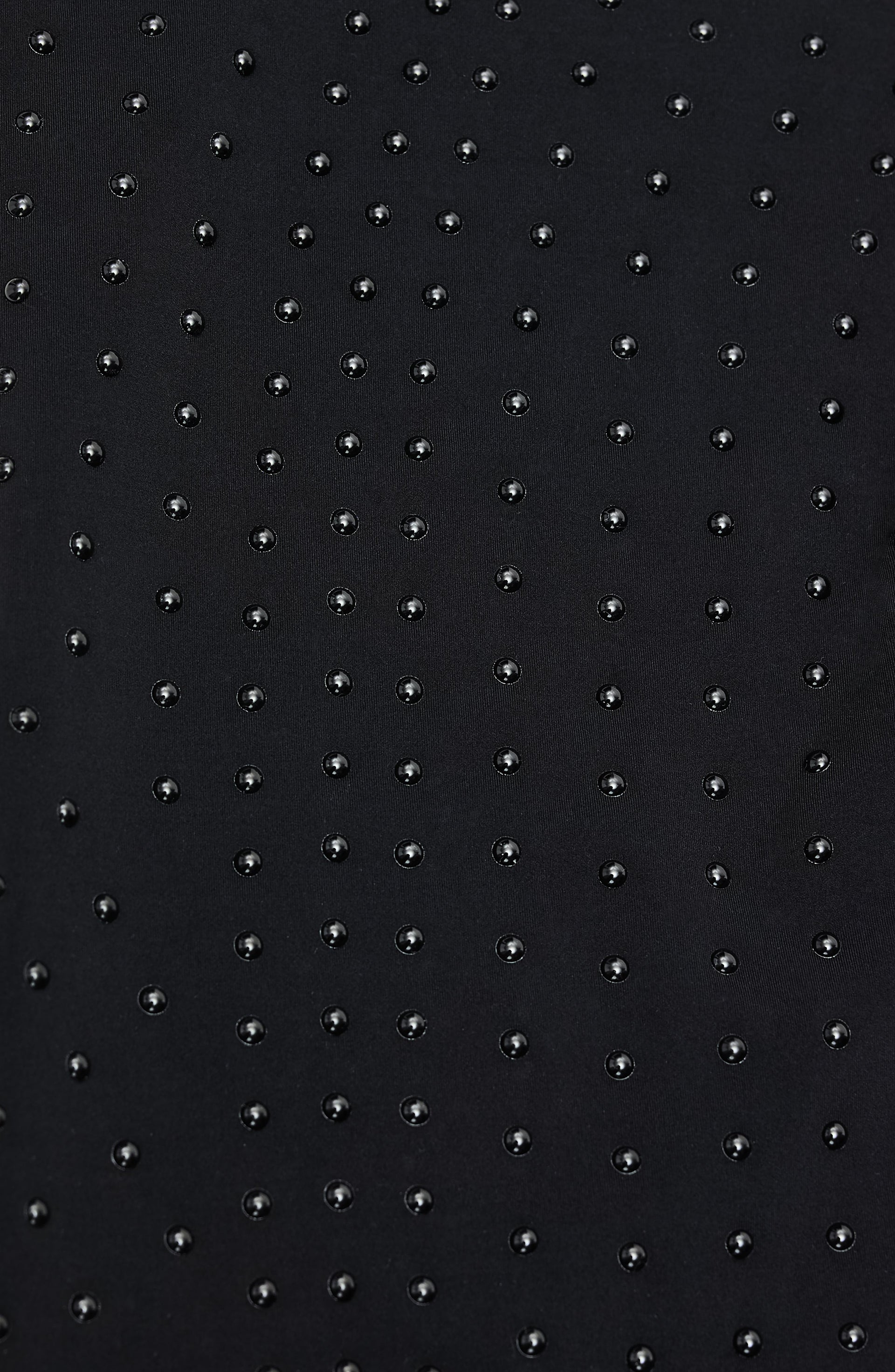 Close up fabric texture detail of the Elastique Athletics L'Original material featuring a subtle dotted pattern on black fabric.
