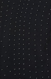 Close up fabric texture detail of the Elastique Athletics Adorn Tank featuring a subtle dotted compression pattern on black fabric.
