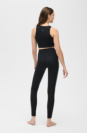 Back view of a woman wearing the Elastique Athletics The Fierce Leggings in black with a matching sleeveless crop top.
