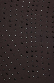 Close up texture detail of the Elastique Athletics Le Monde black fabric featuring a subtle dotted grip pattern.
