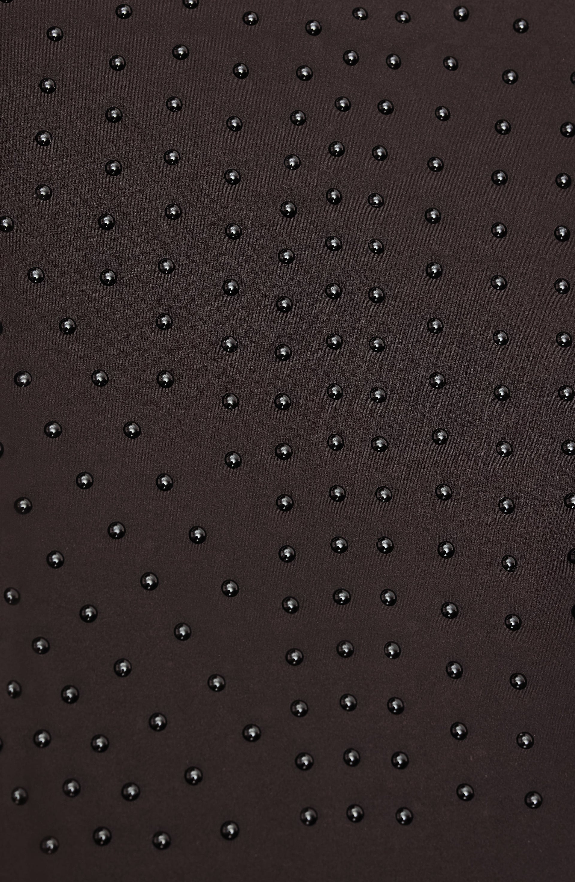 Close up texture detail of the Elastique Athletics Le Monde black fabric featuring a subtle dotted grip pattern.