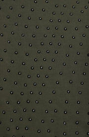 Close up texture detail of the Elastique Athletics Le Divine Lymphatic Bra fabric in olive green featuring a raised dotted compression pattern.