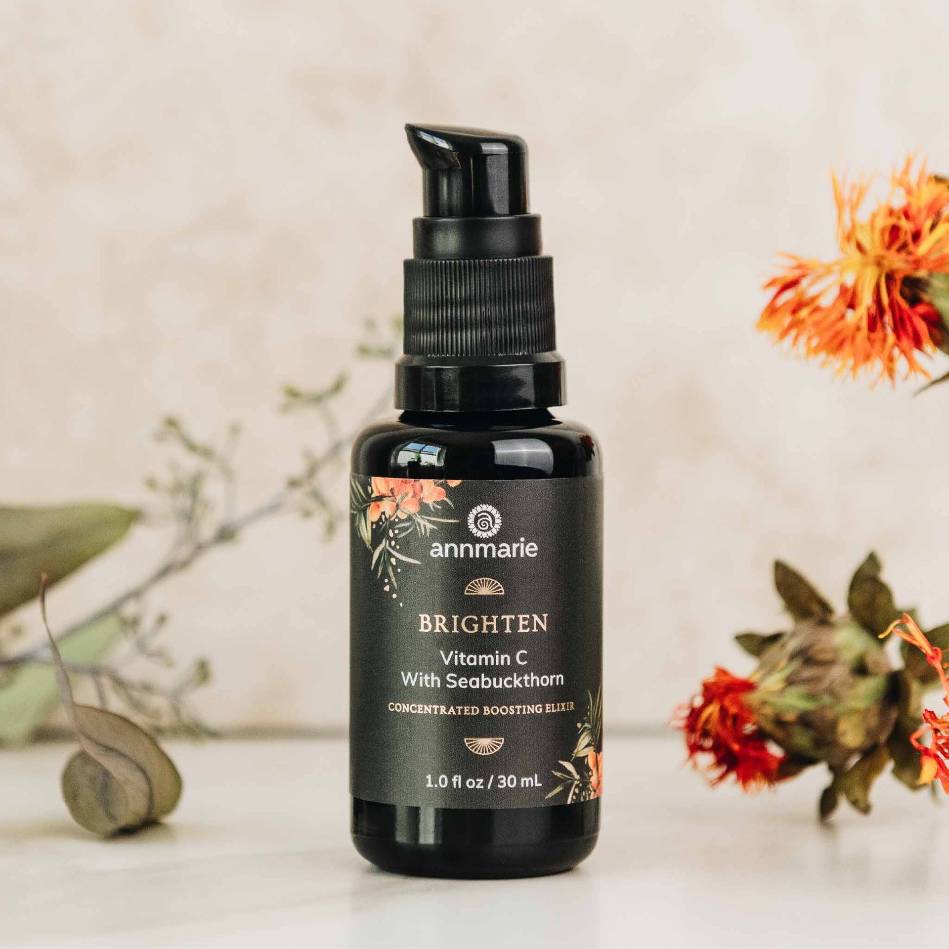 Annmarie Brighten Vitamin C Elixir displayed with botanical ingredients and sea buckthorn
