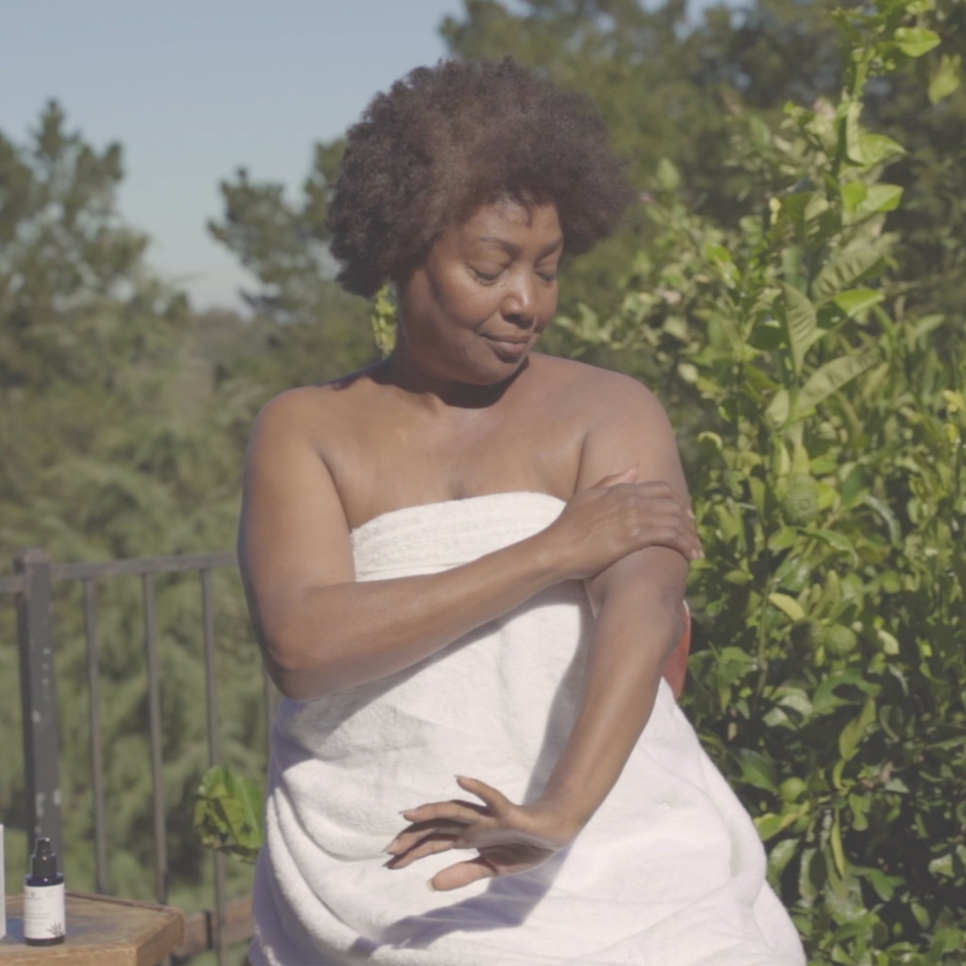 Person applying Annmarie Sun Love sunscreen outdoors as part of a daily skincare routine