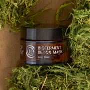 Code of Harmony Bioferment Detox Mask jar styled with green moss