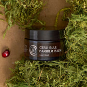 Code of Harmony Ceru Blue Barrier Balm jar styled with green moss