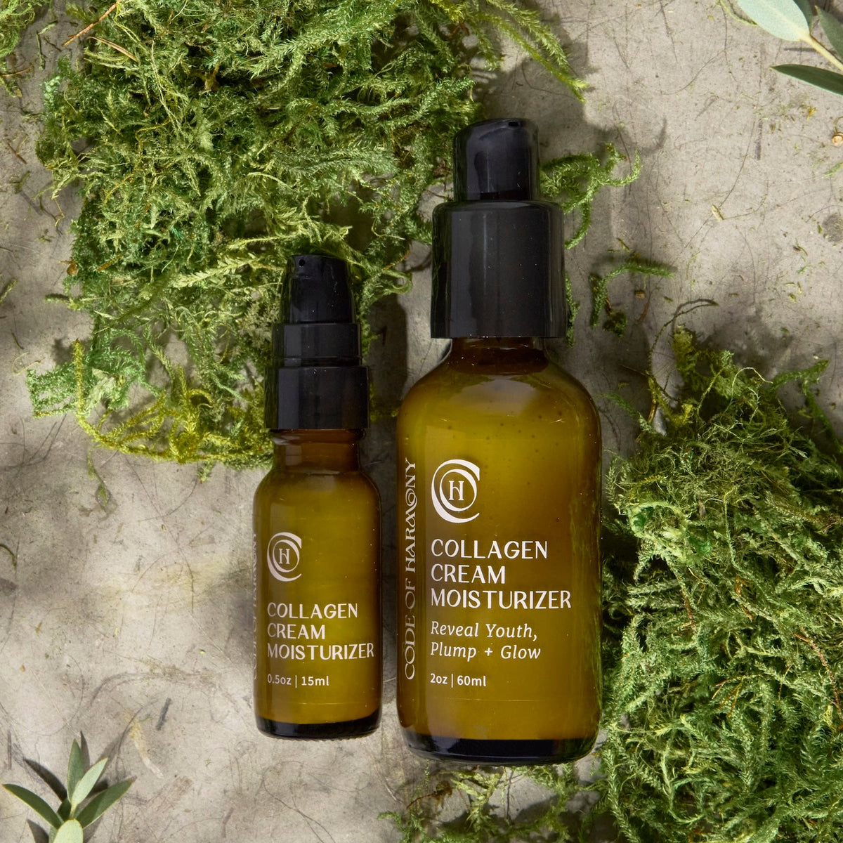 Code of Harmony Collagen Cream Moisturizer 0.5 oz and 2 oz bottles styled with green moss