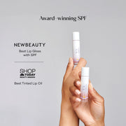 Woman applying Mama Sol LIPBRELLA™ tinted lip oil with SPF 20