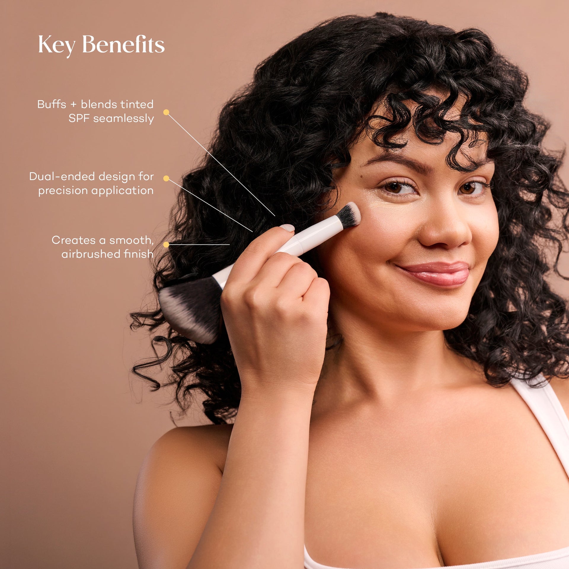 Woman applying complexion product with Mama Sol Buff & Blur makeup brush
