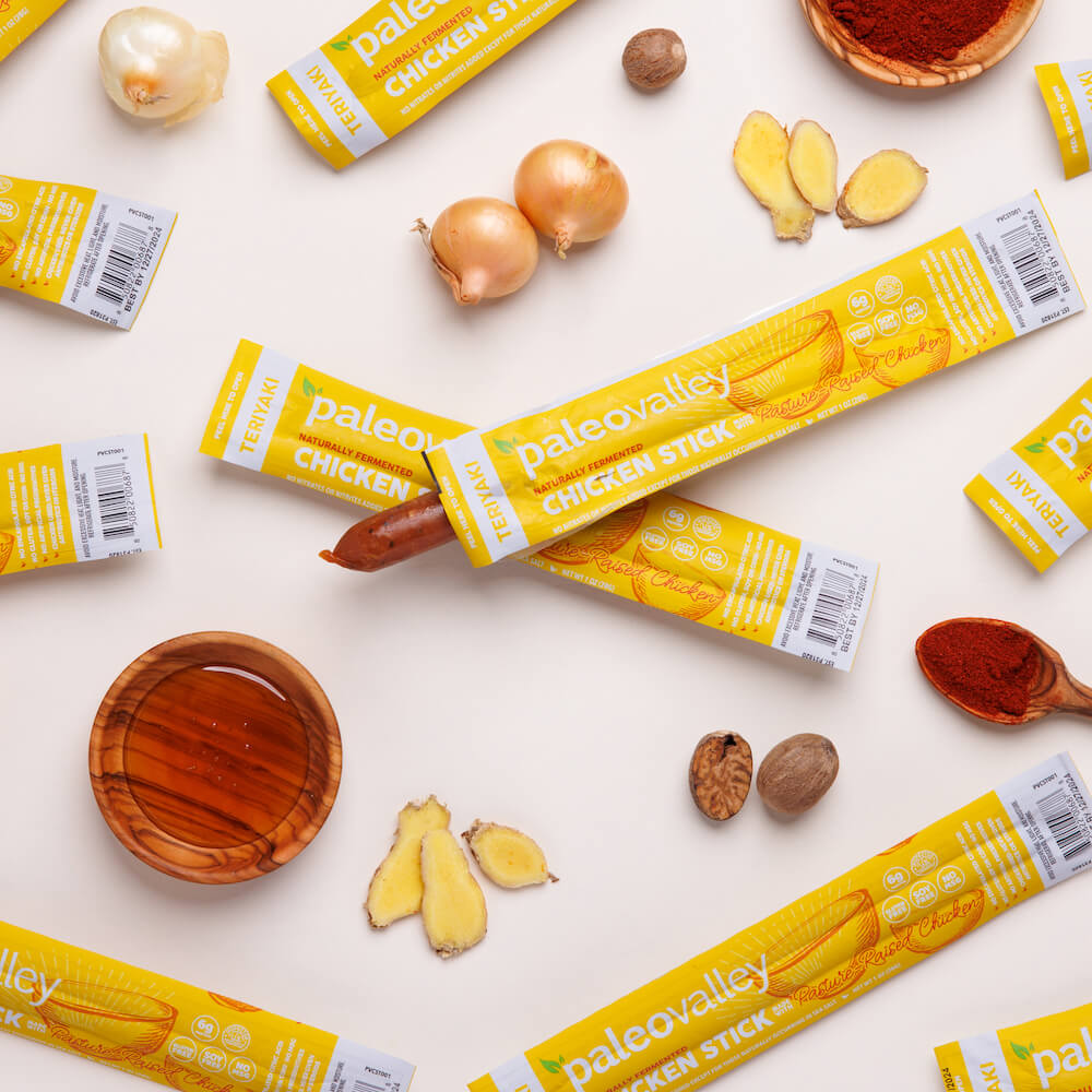 Paleovalley chicken sticks surrounded by real food ingredients for clean snacking