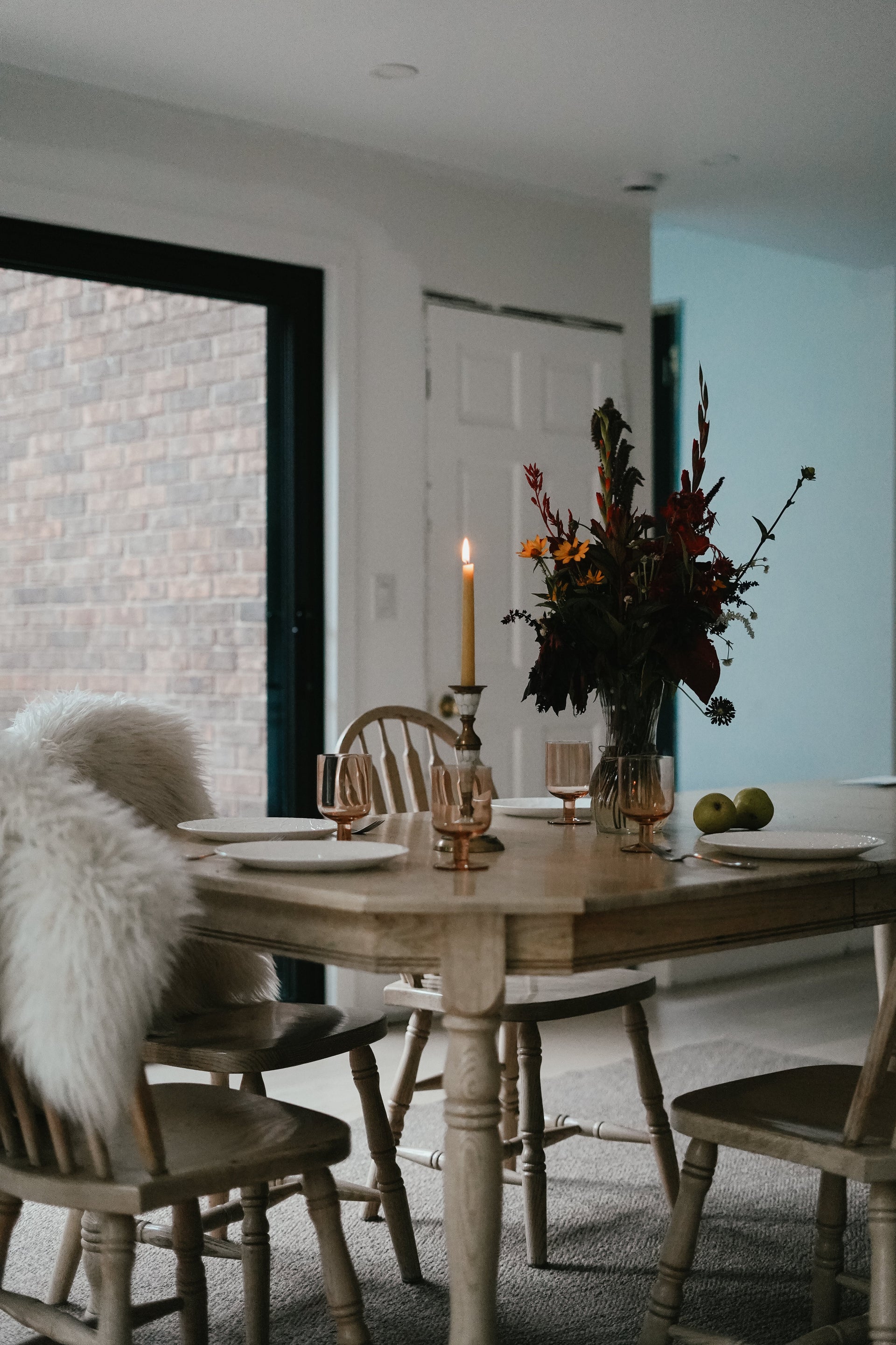 Busy Bees candles from The Queen Bee Bundle styled in a bright dining room beside flowers and natural light.